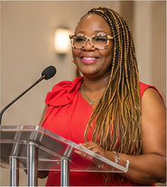 Kena Perry speaking at a podium